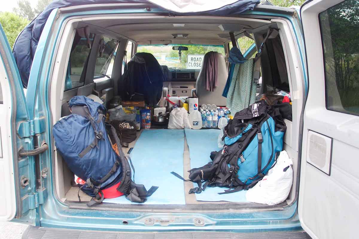 Backpacker car inside with camping equipment