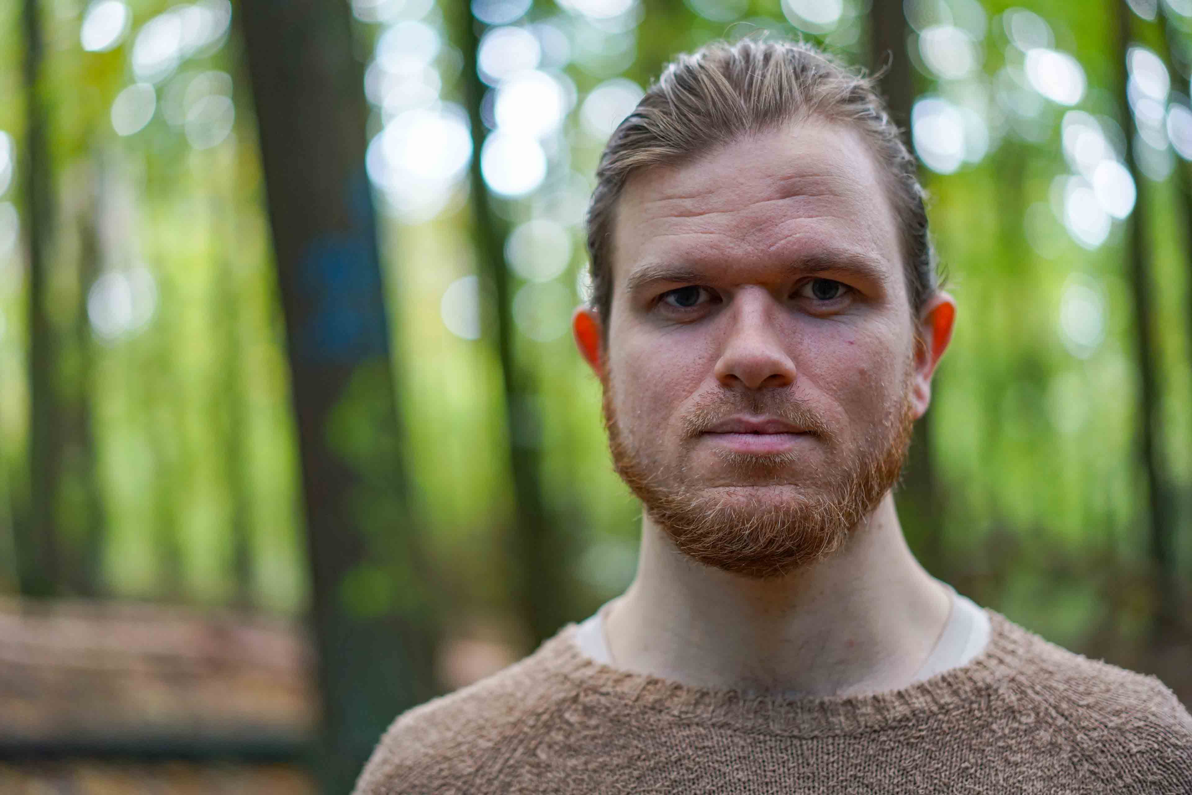 Portrait of man standing in the woods