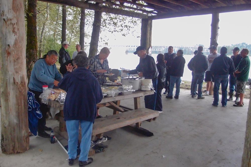 Native Americans and other local people are having barbecue together